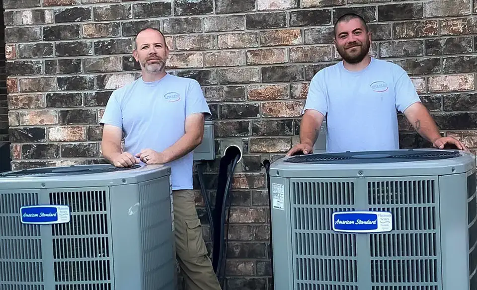  Jeremy, owner of Advantage Heating & Air Conditioning, poses with a technician after a successful AC installation in Wynne, AR.